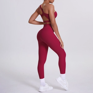 Detail view of burgundy one-shoulder yoga bra and high-waist leggings sports set