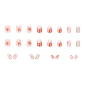 Short round pink press-on nails with rose designs, white hearts, and glitter accents