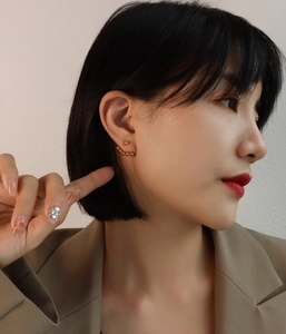 Close-up of a gold stainless steel beaded ear crawler worn by a model for a modern look