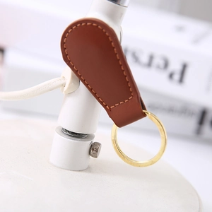 Minimalist brown PU leather magnetic keychain with a gold ring and elegant hand stitching
