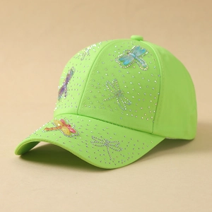 Detail of neon green baseball cap with sparkling rhinestones and colorful dragonfly motifs