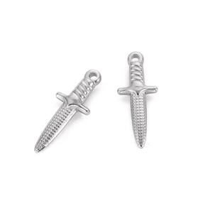 Detailed view of two vintage stainless steel dagger charms with textured metal surface
