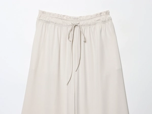 Detailed view of elastic waist and drawstring on beige casual knit trousers for women