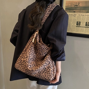 Chic leopard print oversized tote bag with wooden bead detail on shoulder strap