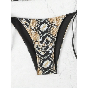 Detailed flat lay of snakeskin print bikini bottom with side ties on stone background