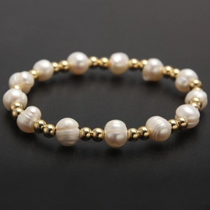 Baroque freshwater pearl bracelet with gold beads on a black background for styling
