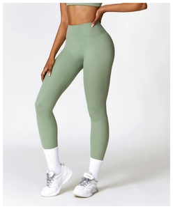Detail of high-waisted yoga leggings in sage green with seamless moisture-wicking fabric