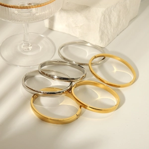 Set of 18K gold and silver minimalist titanium steel bangles with polished finish