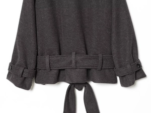 Detail view of the back hem of a dark gray wool coat featuring belt and strap details
