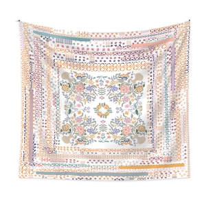 Detail of bohemian mandala tapestry featuring symmetrical floral patterns and pastel tones