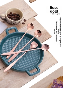 Macro detail of rose gold stainless steel spoons in heart, rose, and cherry shapes
