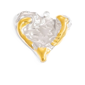 Detailed view of handmade heart pendant featuring two-tone gold and silver hammered metal texture