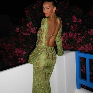 Detail of green knit dress featuring backless cutout and long sleeves for elegant look