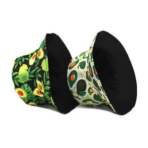 Double-sided avocado print bucket hat in black and white styles with tropical leaf patterns
