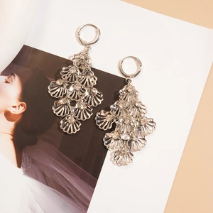 Detail of silver leaf tassel earrings with sparkling rhinestones and hollow fan design