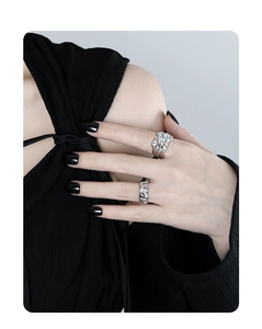 Detail of irregular liquid metal silver ring and thin diamond band on a model