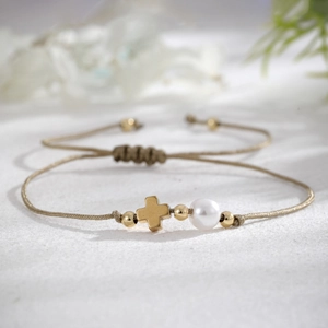 Handmade woven cross bracelet with faux pearls and golden accents for women