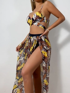 Three-piece bikini set with tropical leaf print and a long sheer mesh cover-up skirt