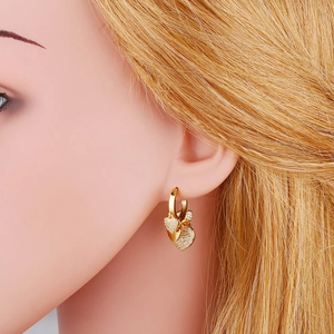 Gold heart drop earrings with shimmering micro-pave zircons and smooth metallic finish