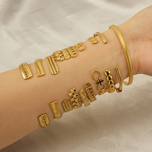French vintage style stackable gold stainless steel bracelets shown on wrist