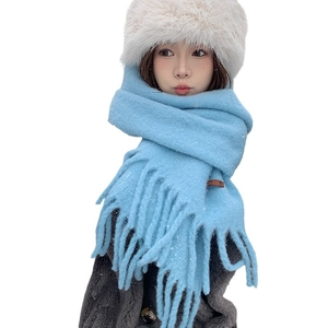 Sky blue knit wool scarf with fringe on model, elegant winter accessory for women