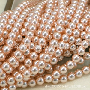 Macro shot of high-luster pink round pearls for DIY jewelry making and necklace crafts