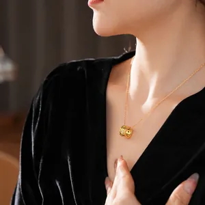 Collana con ciondolo a cilindro a stella in titanio dorato su abito di velluto