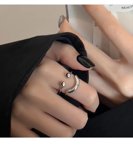 Detailed view of silver smiley face double-layer open ring on model finger