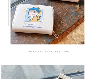 Detail of white PU leather card holder featuring a cartoon girl with pearl earring print