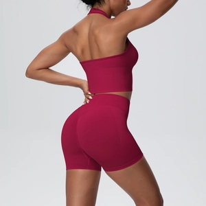 Macro detail of wine red ribbed knit fabric on halter yoga top and high waist shorts