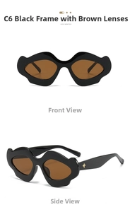 Detail of punk style wavy irregular black frames with tea lenses and gold star accent
