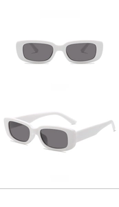 Detail view showing front and side of white square frame sunglasses with grey lenses