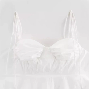 Slim fit white camisole top with asymmetrical hem and thin lace-up straps for women