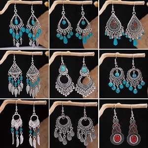 Detailed grid of bohemian silver earrings with turquoise stones and leaf tassel accents