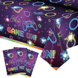 Deep purple game controller themed tablecloth with neon stars and Game On text for party decor