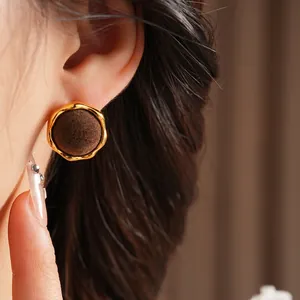 Vintage gold metal earrings with dark brown velvet flocking inlay and wavy edges