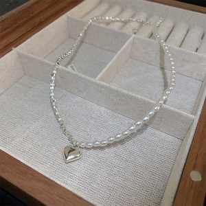 French style pearl and silver chain necklace with heart pendant in a wooden jewelry box