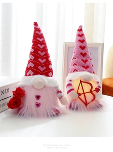 Detail of two Valentine gnomes with LED lights, heart hats, and roses for gift decor