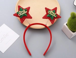 Detail of red Christmas star headband with gold Merry Christmas lettering and glitter