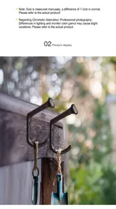 Industrial vintage cast iron nail hook detail showing matte black finish on wood wall
