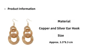 Detailed view of gold concentric spiral rings with 925 silver hooks measuring 3.5x8.3cm
