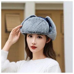Detailed view of the soft faux fur lining on a blue windproof winter earflap hat