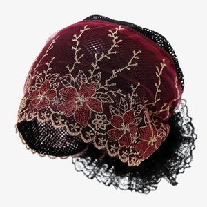 Detailed embroidery of floral patterns on burgundy lace turban for women with gold accents