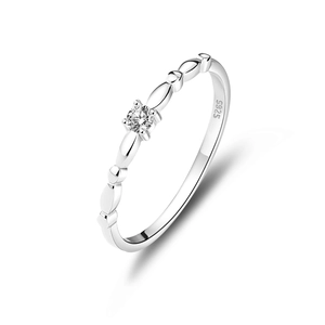 Macro shot of polished S925 sterling silver ring featuring a sparkling round solitaire stone
