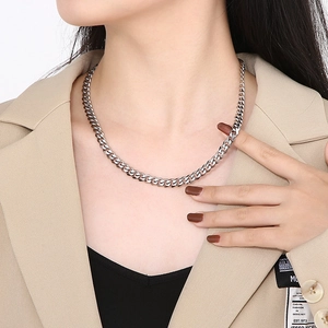 Silver stainless steel Cuban link chain necklace shown on a model neck for styling