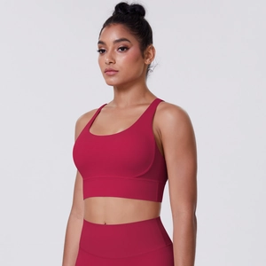 Detail of cross-back sports bra featuring brushed fabric and high elasticity in deep red
