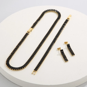 Luxury gold titanium steel jewelry set with black rectangular zircon stones on a white base