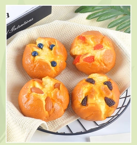 Top view of four realistic PU muffin cake models with blueberry and strawberry toppings