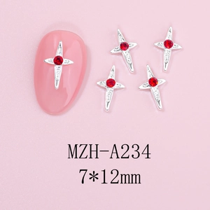 Macro view of cross-shaped alloy nail charms with red rhinestones and silver finish