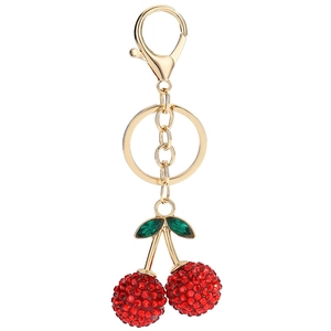Rhinestone cherry keychain with green leaves and gold lobster clasp on white background